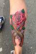 Red rose and cross pistols calf tattoo